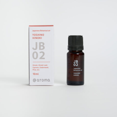 JB02 Yoshino Hinoki aroma oil with paper packaging next to the small brown bottle