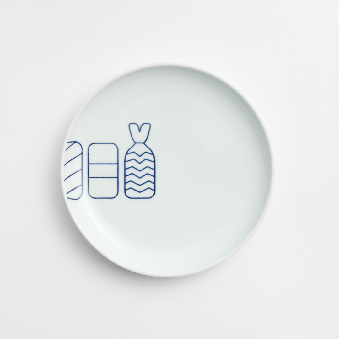 A white arita porcelain plate with a blue line drawing of a prawn sushi, egg sushi and salmon sushi