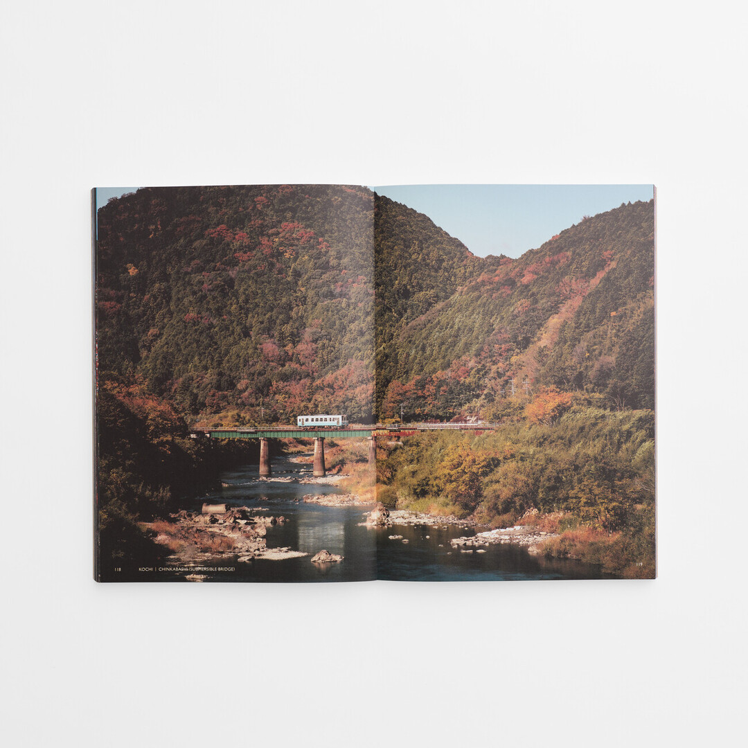 A page spread showing an autumn scene of a mountain with a river running through