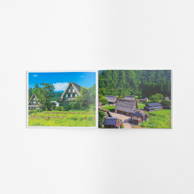 A page spread with two photographs of thatched roof houses next to fields