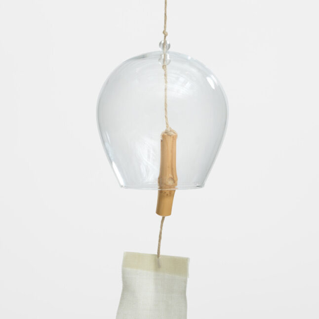 A glass wind chime with a root bamboo node and linen sail