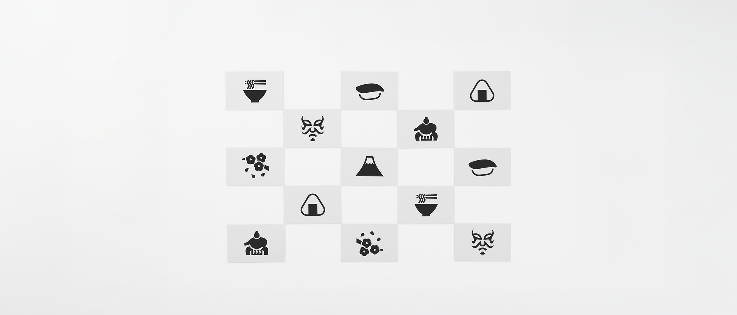 Thirteen black and white postcards with pictograms from Japan placed in a chequered formation