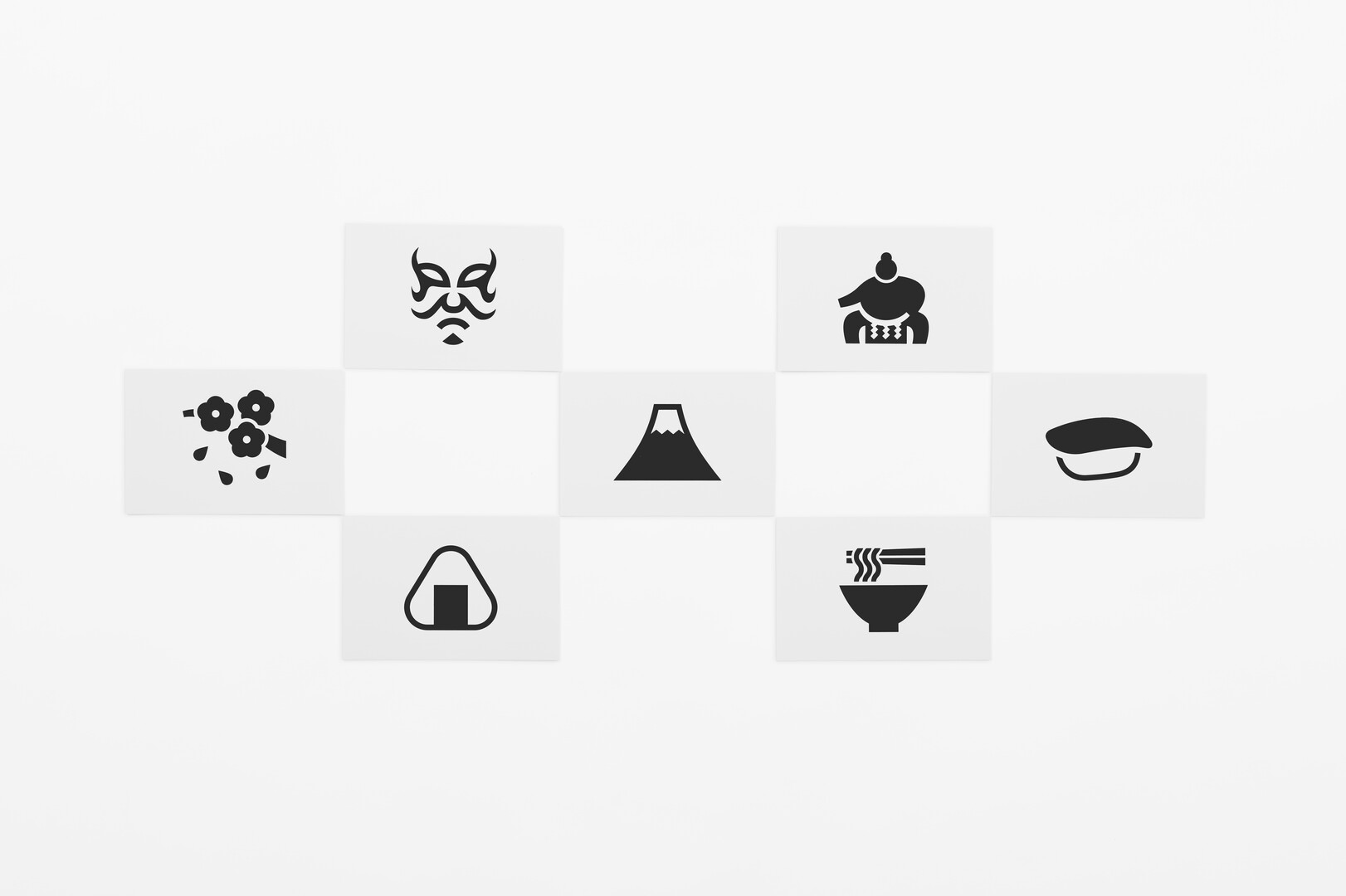 Seven black and white postcards with pictograms from Japan placed in a chequered formation