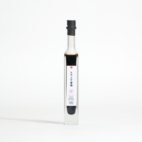 Truffle soy sauce in a thin transparent bottle with a long neck