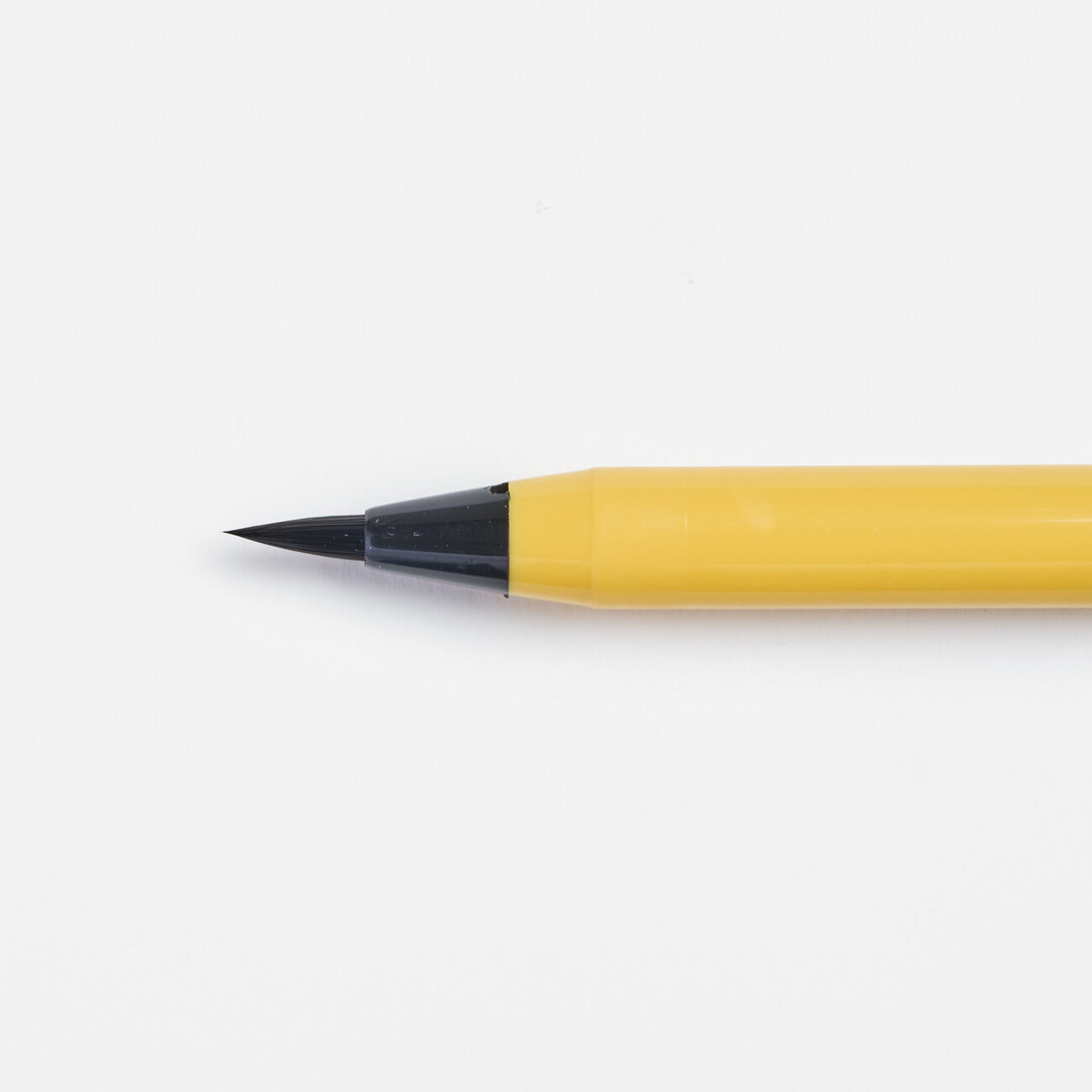 A brush tip of the soft tip pen with yellow body