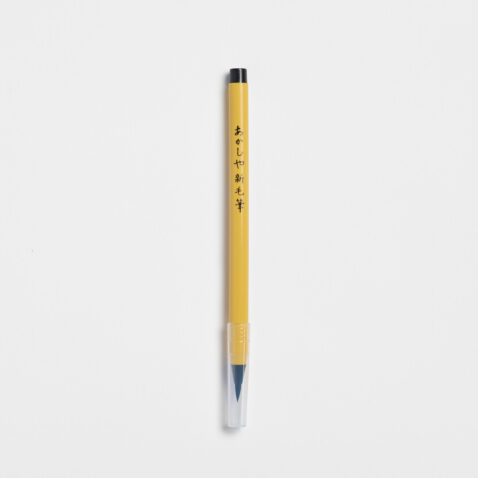 Soft tip pen with brush tip and yellow body