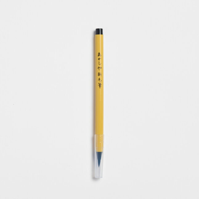 Soft tip pen with brush tip and yellow body