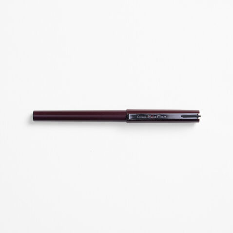 A Pentel Pulaman Pen with black ink in a maroon body and silver clip function on lid