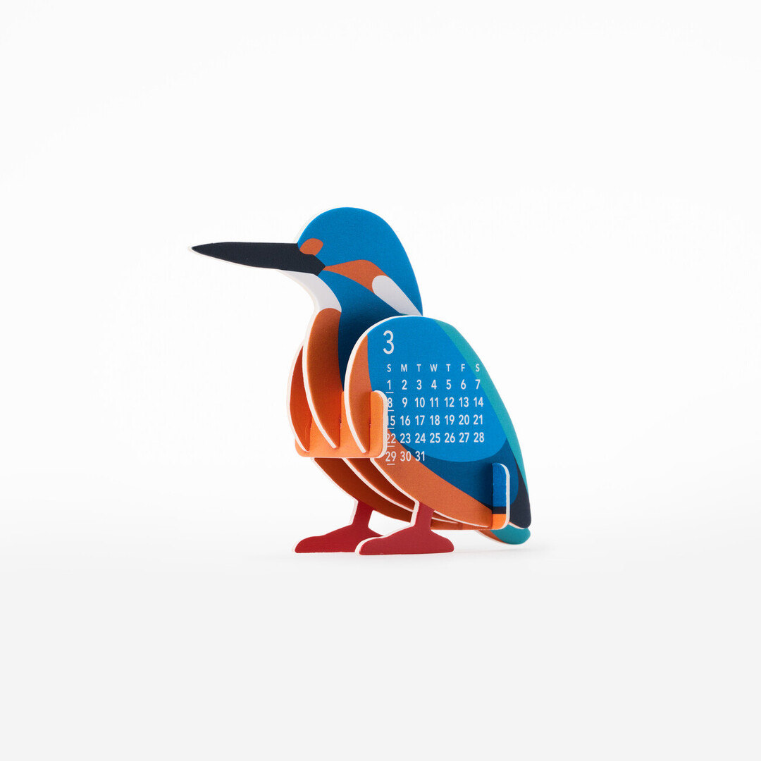 A three dimensional paper calendar in the shape of a king fisher with the months of March and April on the side from Japan House London