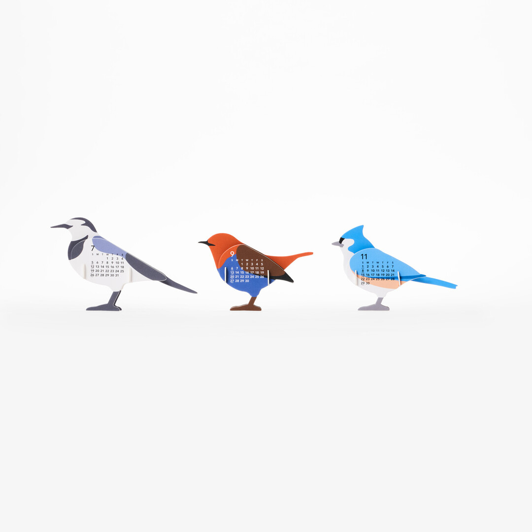 A three dimensional paper calendar in the shape of birds showing three birds in a row from Japan House London