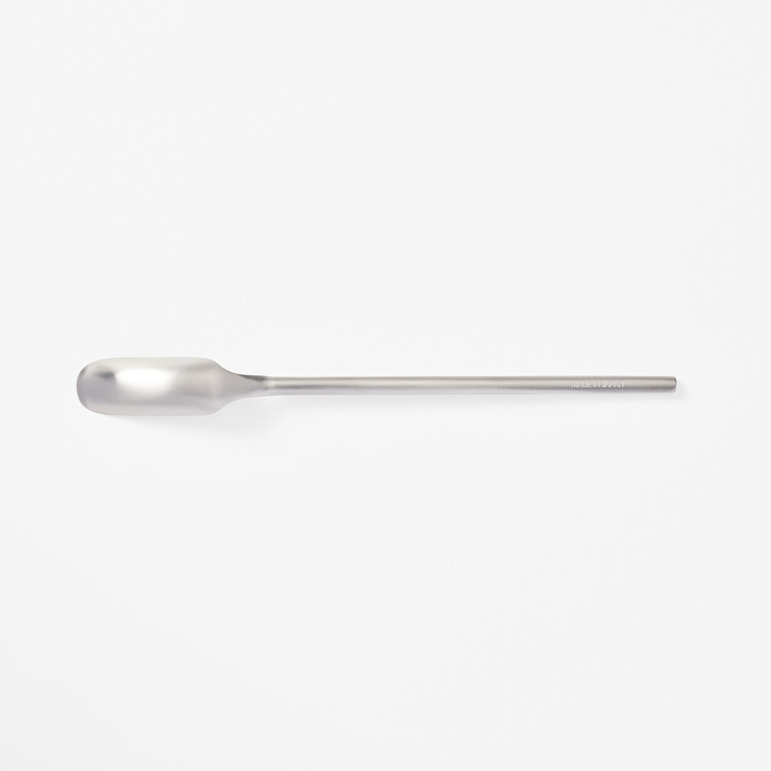 A stainless steel slim spoon with a long handle and narrow head from Japan House London