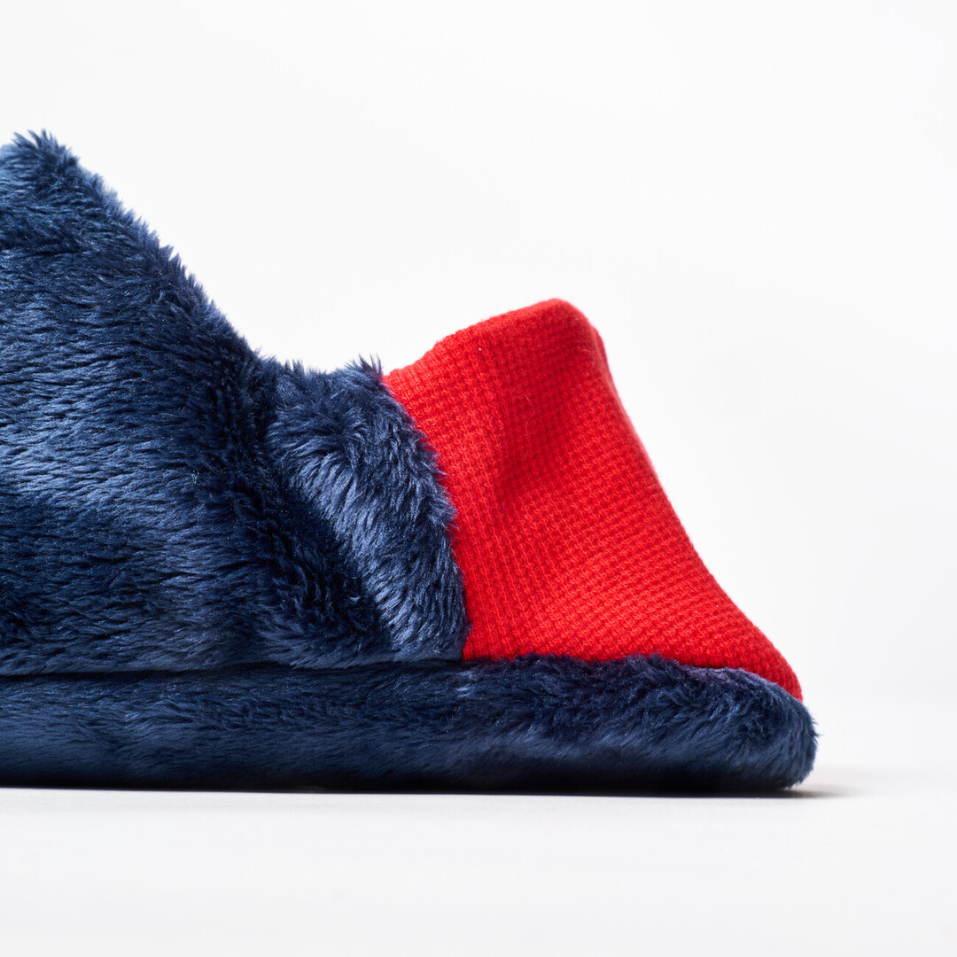 A reversible slipper with a navy blue with speckle fabric with a red ribbed heel from Japan House London.