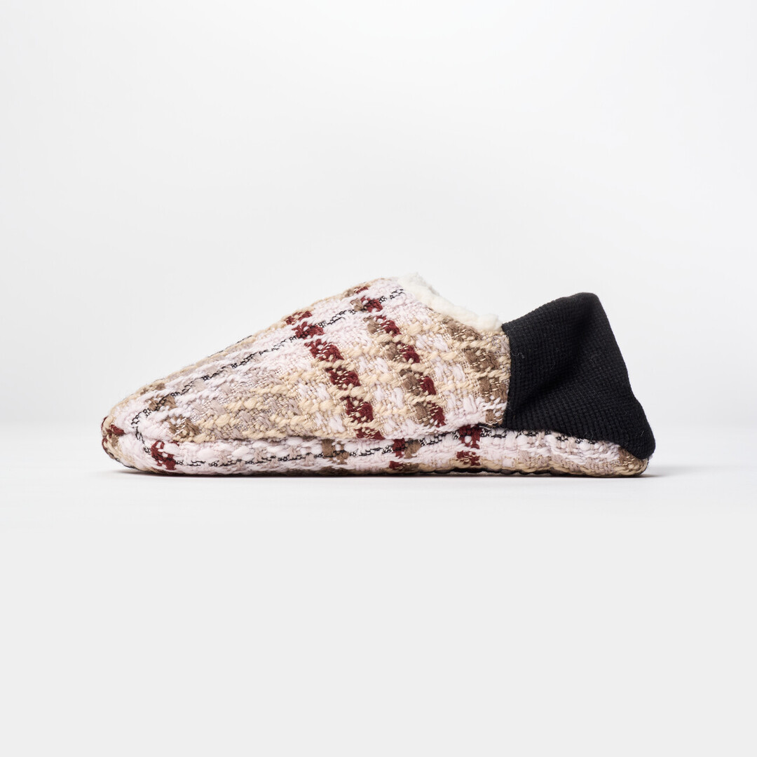 A reversible slipper with a white and brown tartan fabric with a black ribbed heel from Japan House London.