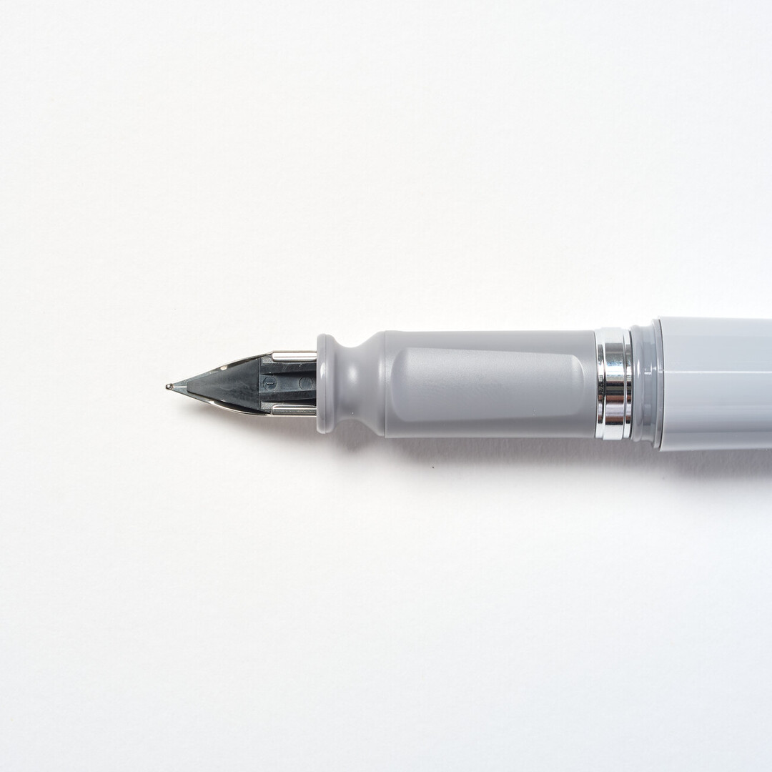 Tuzu Fountain pen by Sailor with grey body and steel nib angled from Japan House London.