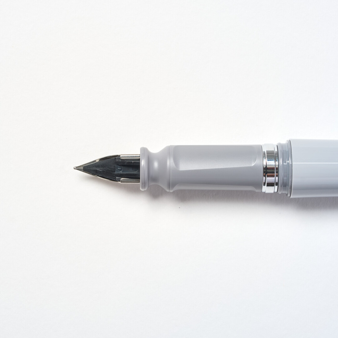 Tuzu Fountain pen by Sailor with grey body and steel nib angled from Japan House London.
