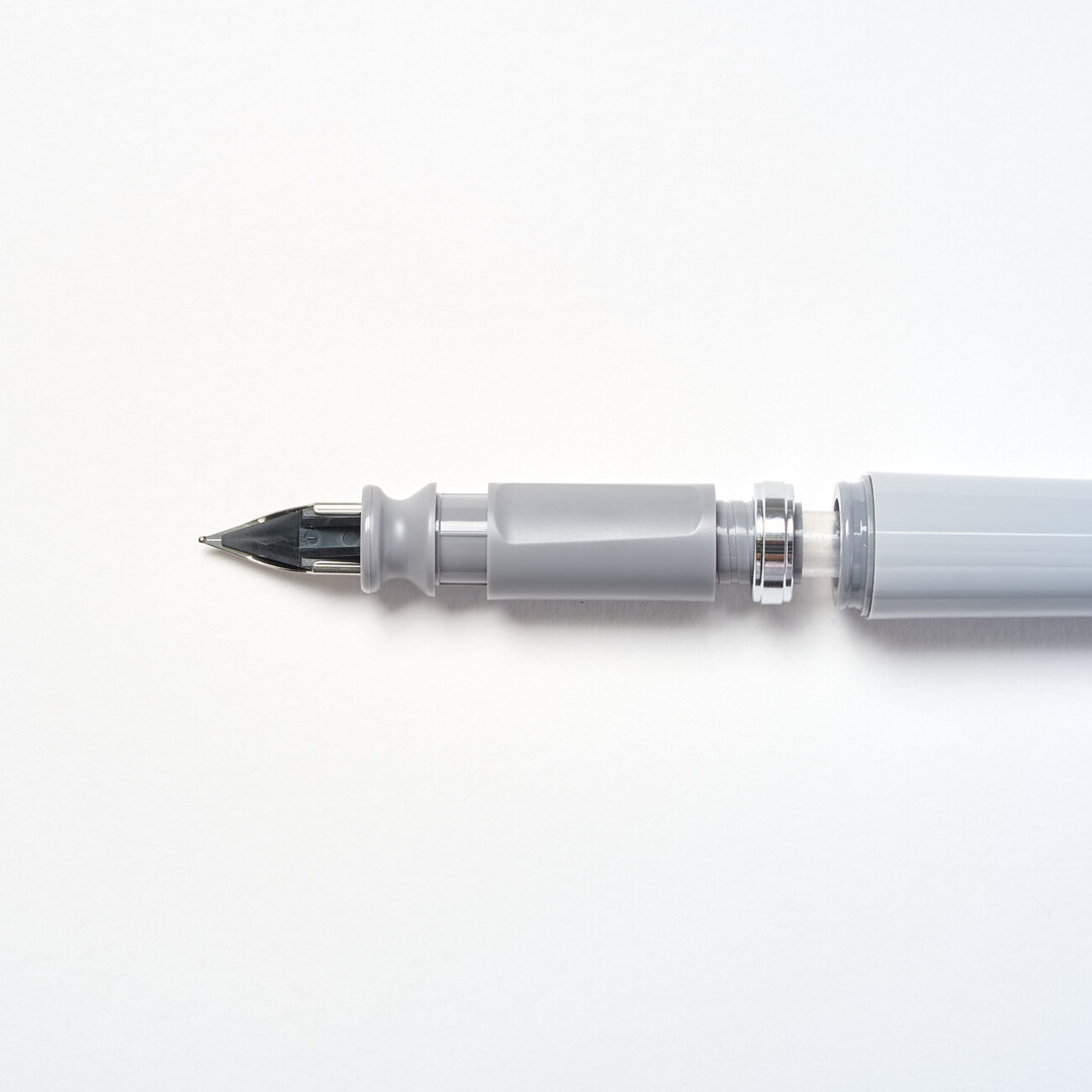 Tuzu Fountain pen by Sailor with grey body and steel nib angled from Japan House London.