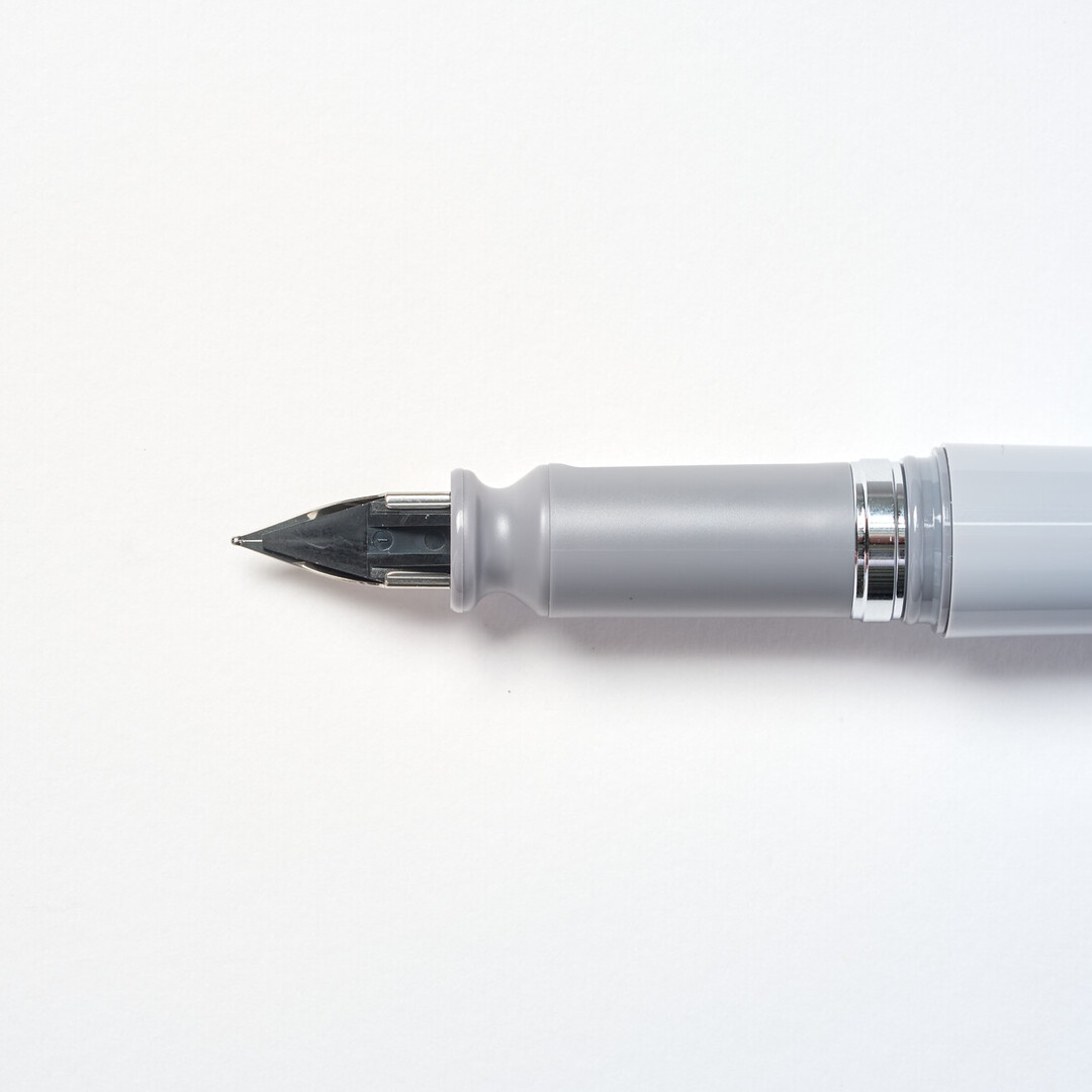 Tuzu Fountain pen by Sailor with grey body and steel nib angled from Japan House London.