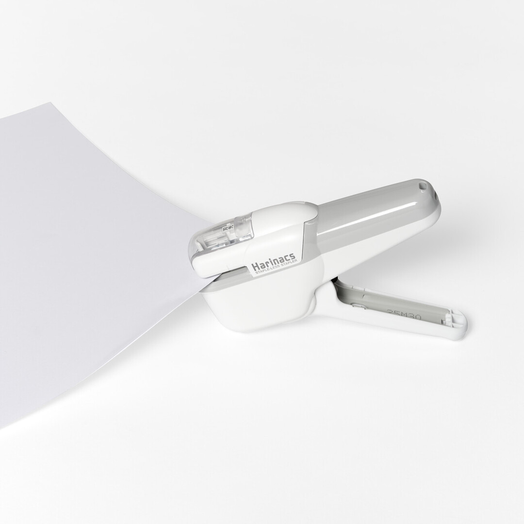 KOKUYO Harinacs Stapleless Stapler in white stapling two sheets of paper together from Japan House London.