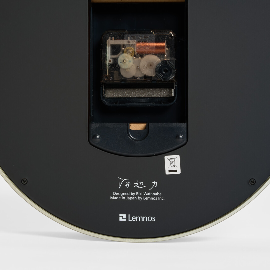 The back of the white Riki Ring Clock with the signature of the deisgner Watanabe Riki from Japan House London.