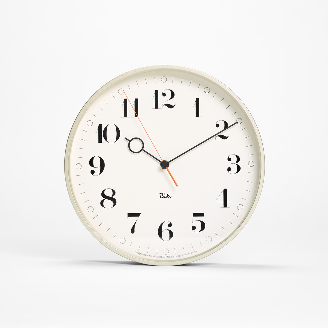 The white wall Riki Ring Clock with silver frame from Japan House London.