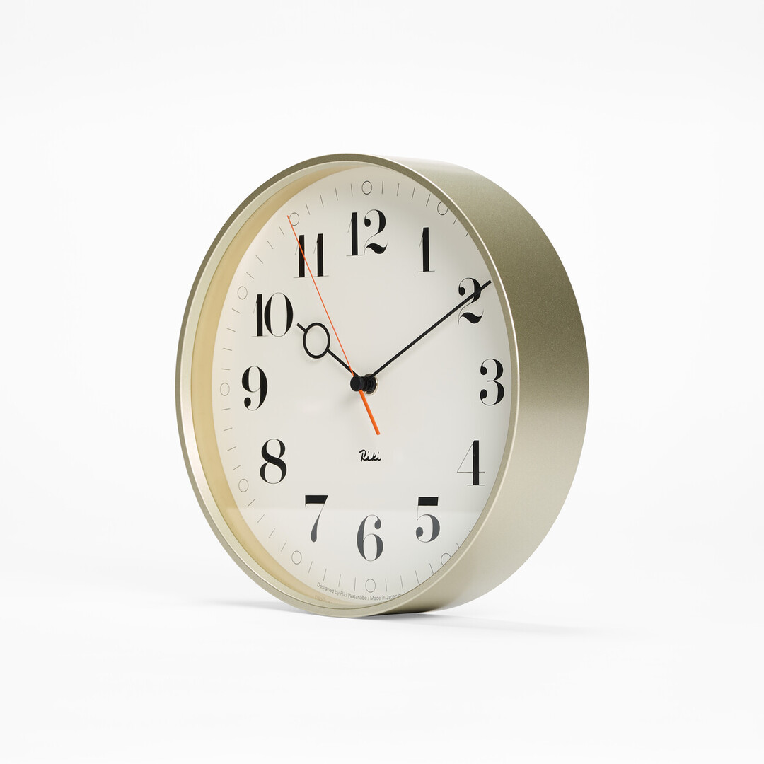The white wall Riki Ring Clock with silver frame from Japan House London.