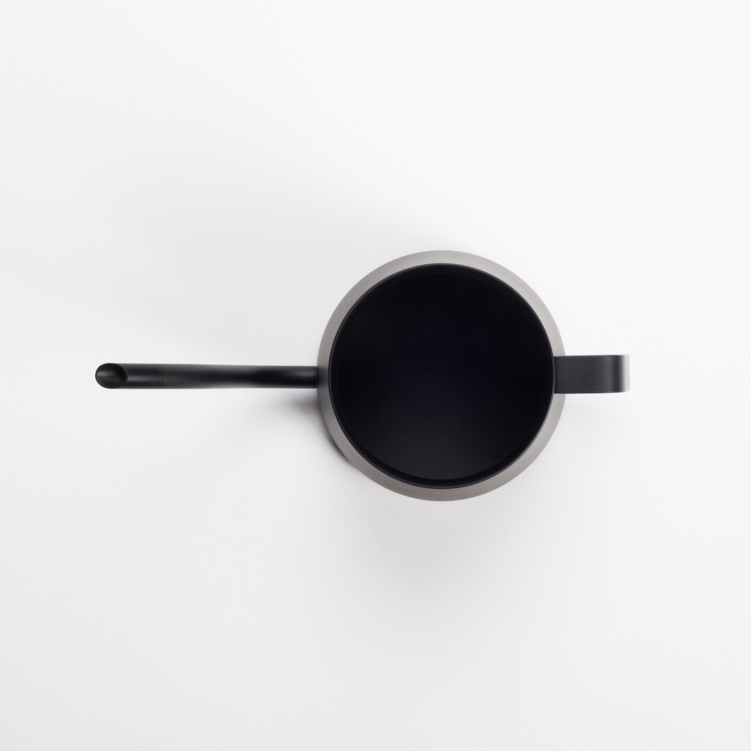 A black Hario Kasuya Mini Drip Kettle 300ml for pouring hot water over coffee grounds from Japan House London.