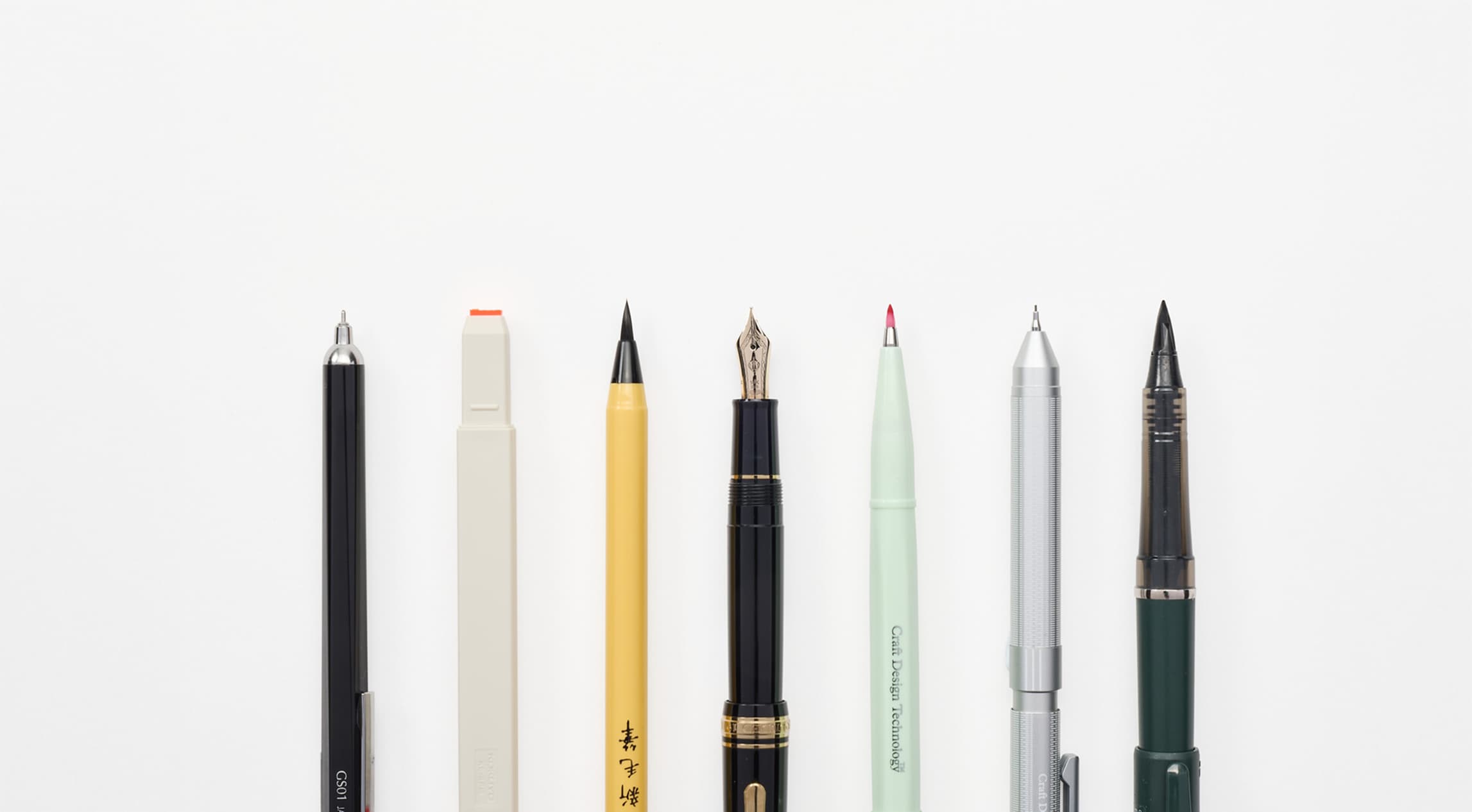 A row of seven writing utensils from Japan House London.