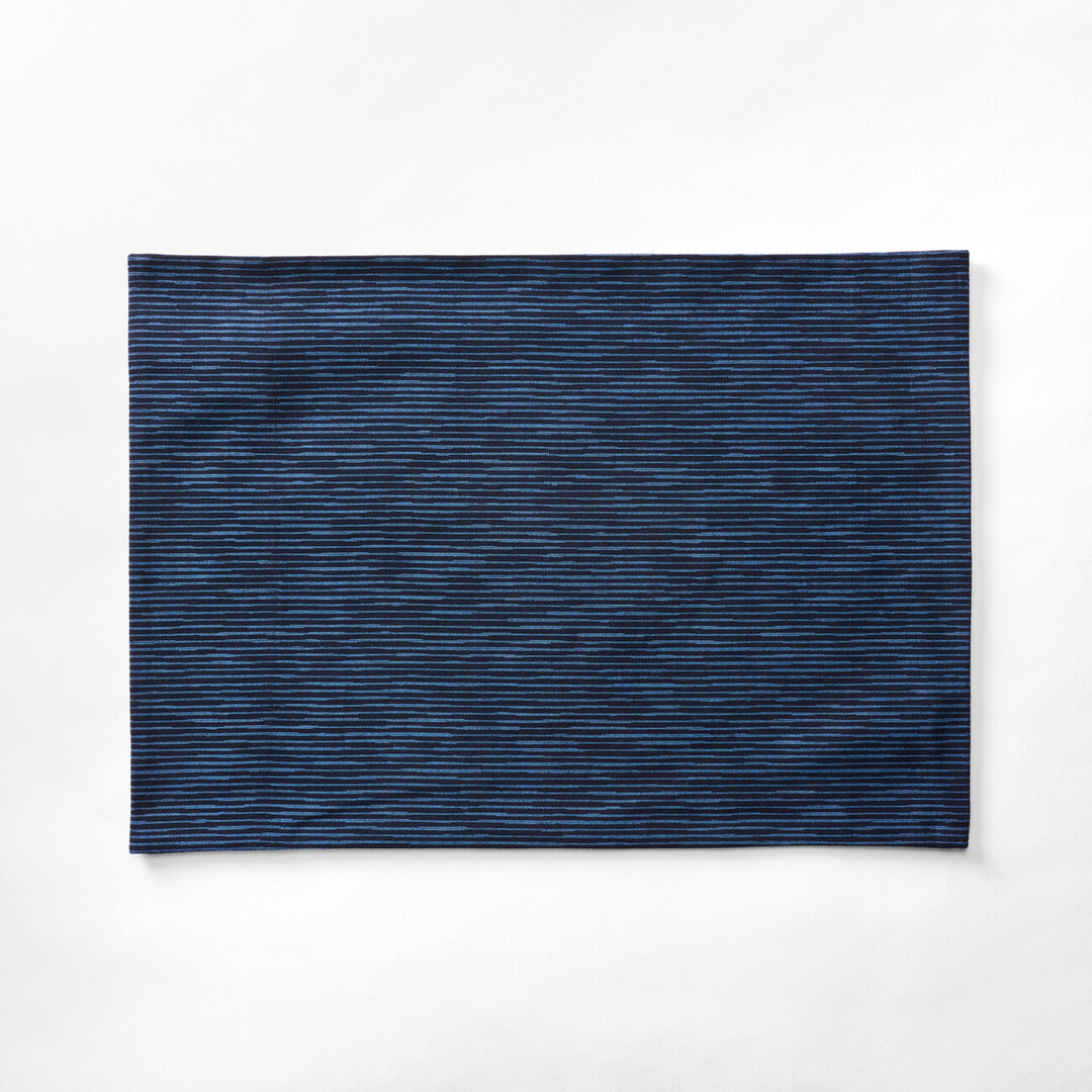 Dark blue Kurume Kasuri tablemat with fine stripes by Okamoto Shōten from Japan House London.