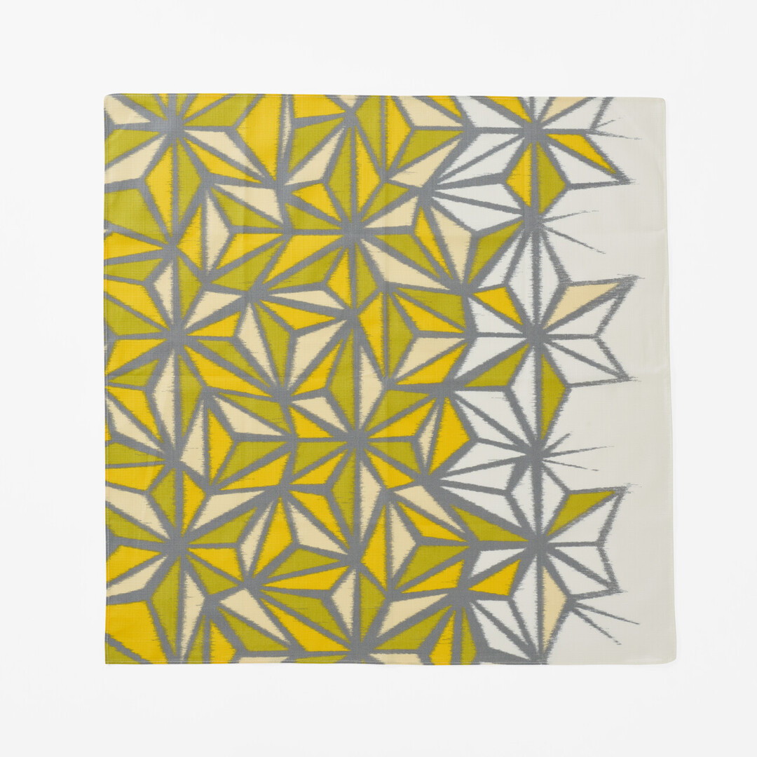 The front of a hemp leaf design furoshiki going from white to yellow and green from Japan House London.