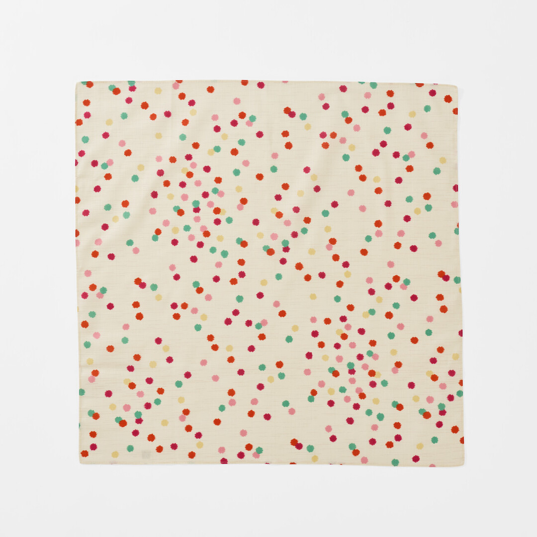 The front of Furoshiki Kompeito which has a cream background with multi colour small dots from Japan House London.