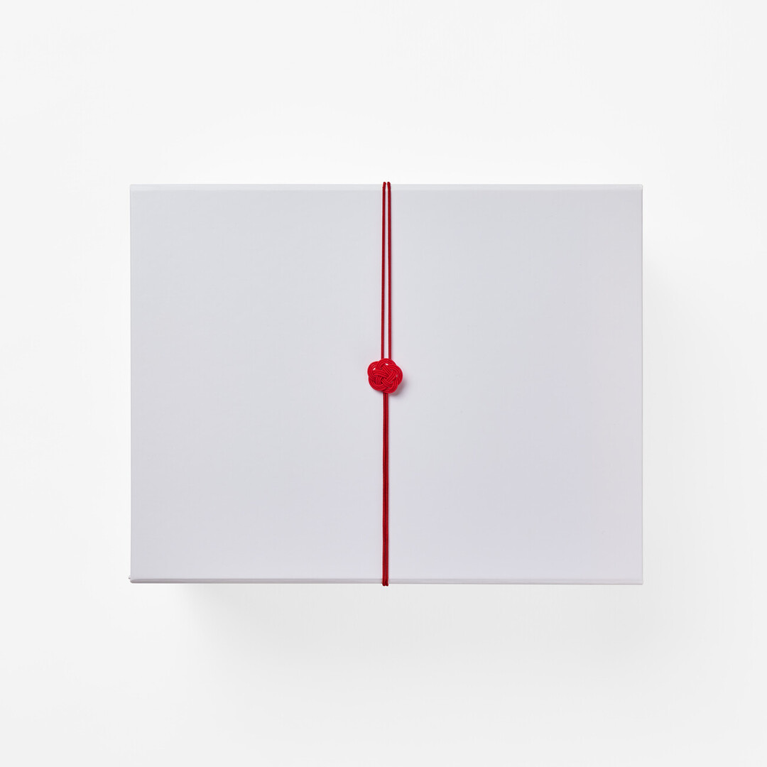 A white giftbox with a red mizuhiki around the middle from Japan House London.