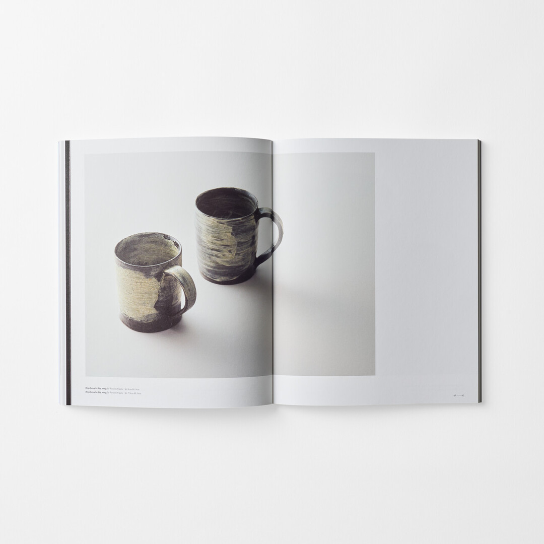 A spread in the book Utsukushi Utsuwa with two ceramic cups from Japan House London.