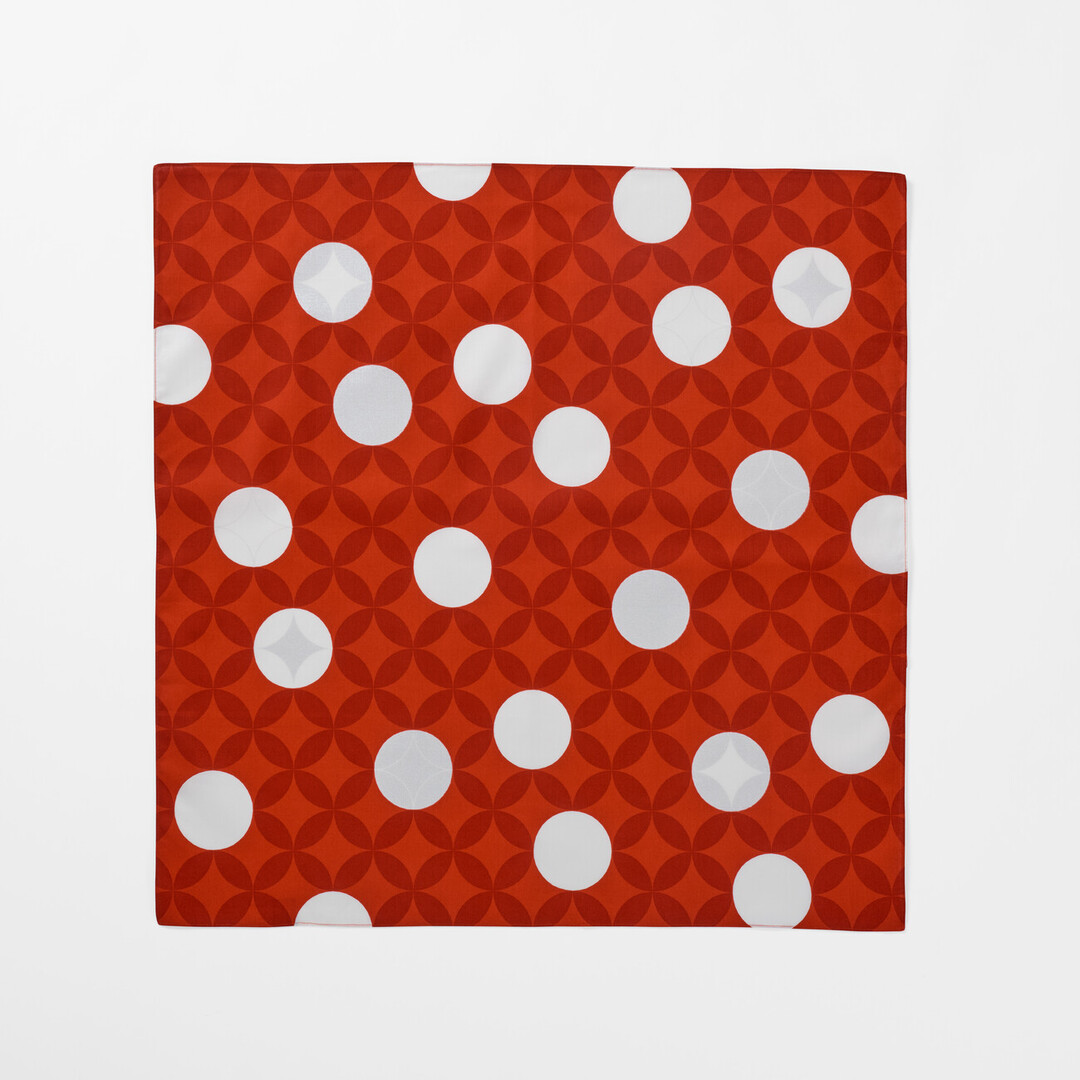 The Furoshiki Seven Treasures with a red background and white circles from Japan House London.