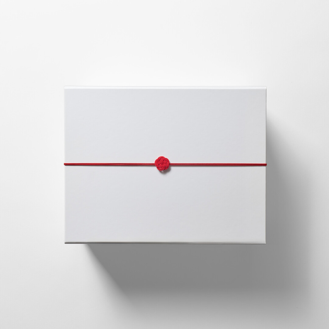 A large white gift box with a red mizuhiki from Japan House London.