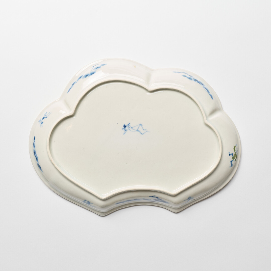 A cloud shaped plate with illustration of horses in blue by Hidaka Naoko from Japan House London.