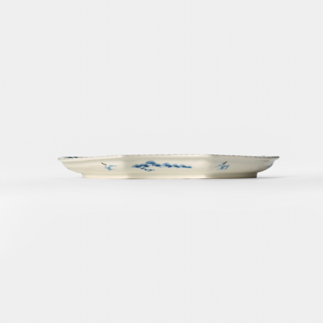 A cloud shaped plate with illustration of horses in blue by Hidaka Naoko from Japan House London.