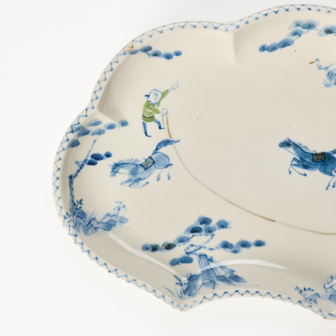 A cloud shaped plate with illustration of horses in blue by Hidaka Naoko from Japan House London.