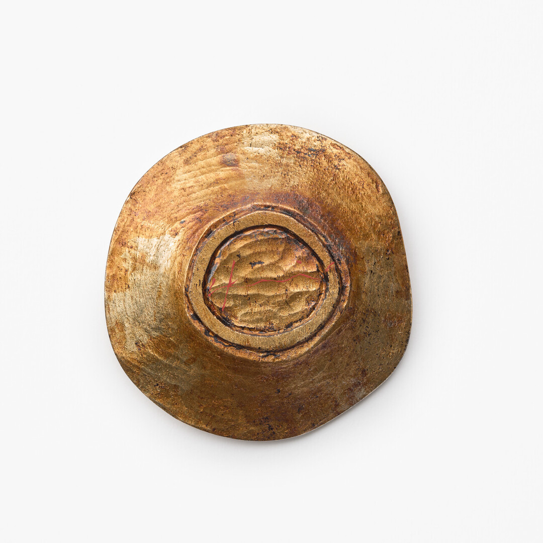 A wooden tea saucer with silver leaf and urushi finish by Urakami Yosuke from Japan House London.