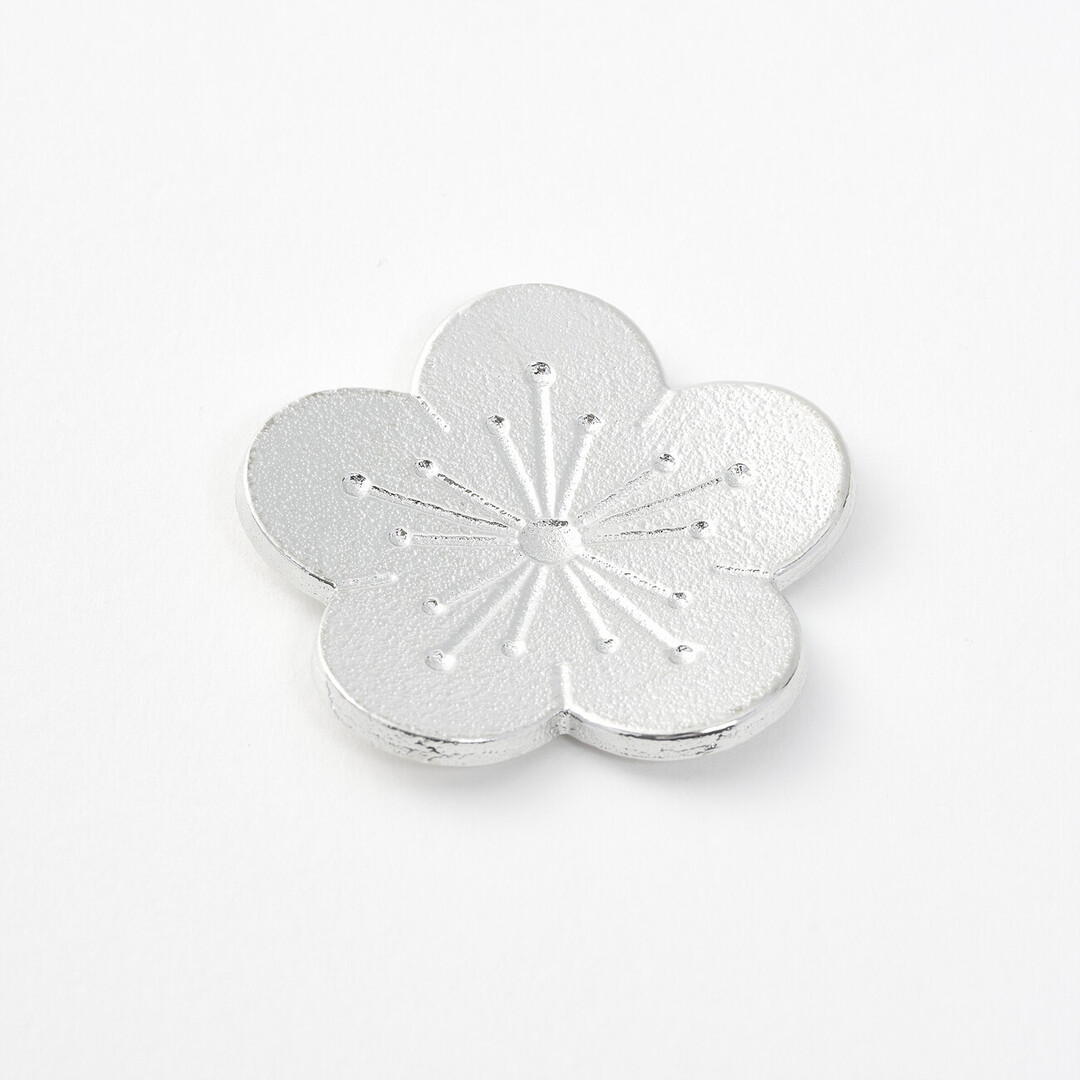 Plum flower shaped tin chopstick rest by Nousaku from Japan House London.