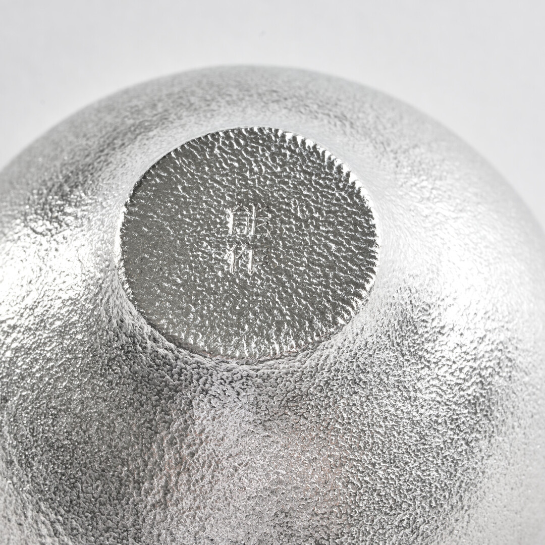 Foot of the rounded tin sake cup by Nousaku from Japan House London.