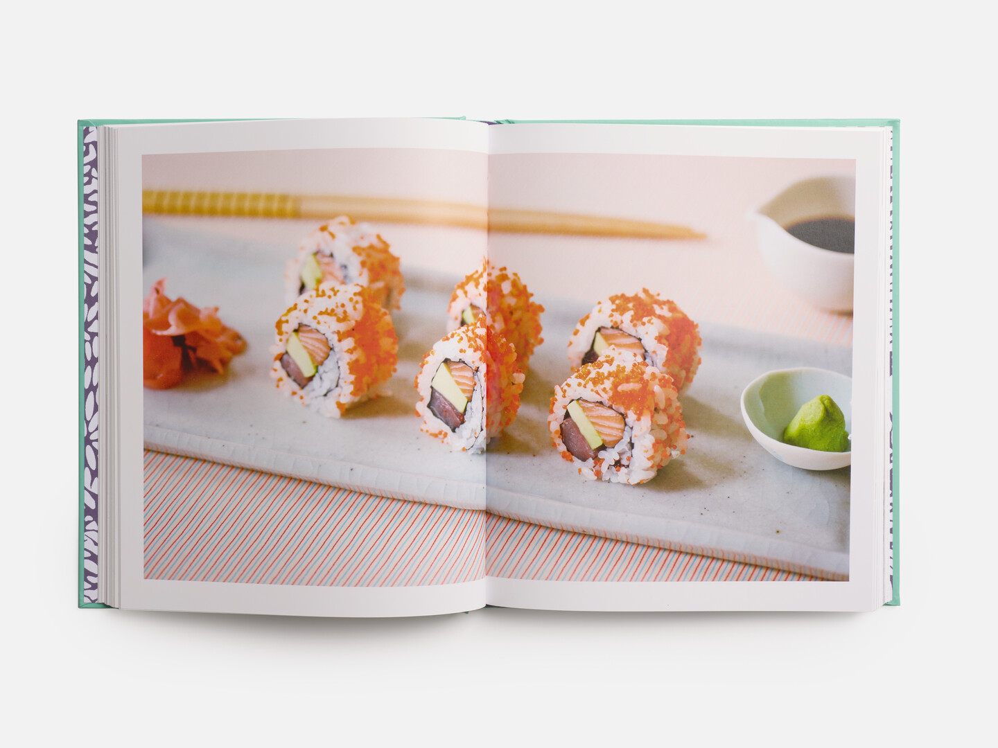 A spread with an image of a sushi roll from Sushi at Home by Gomi Yuki from Japan House London.