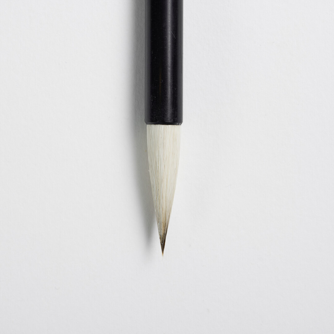 A calligraphy pen size 6 with black handle and white brush by Akashiya from Japan House London.
