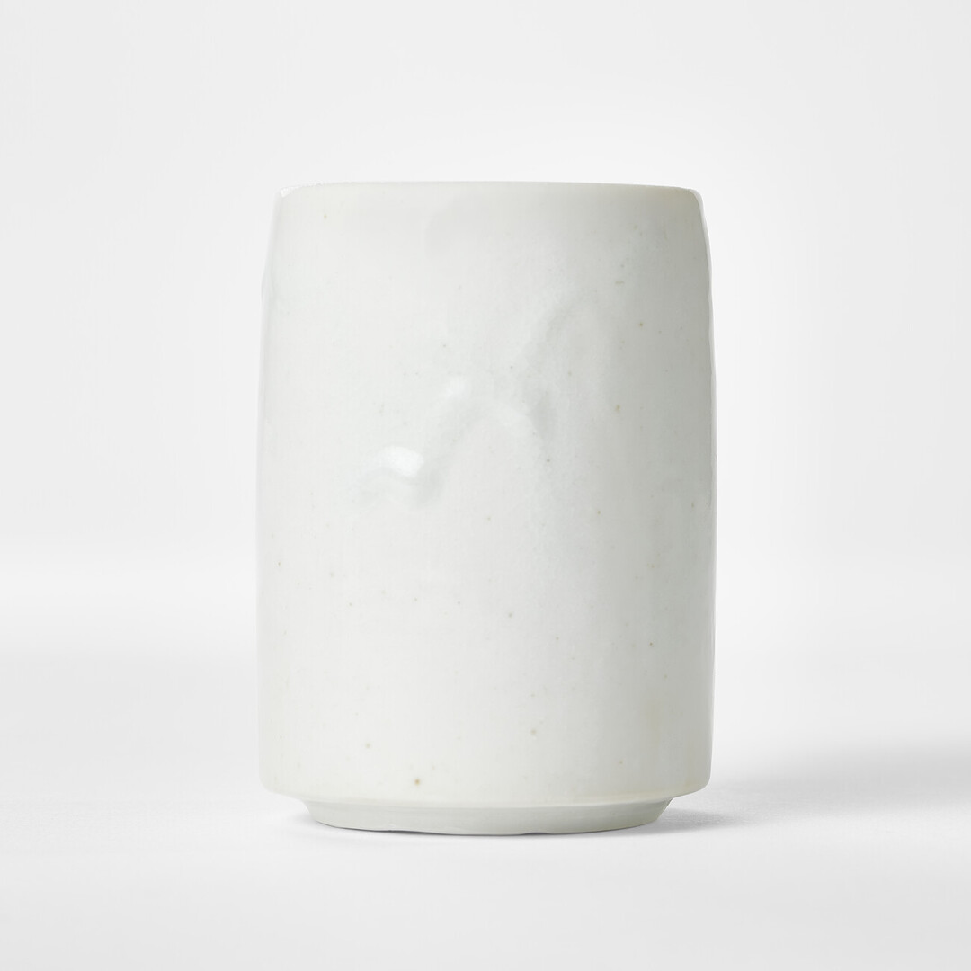 A tall blue and white porcelain teacup by Takeshita Tsutomu from Japan House London.