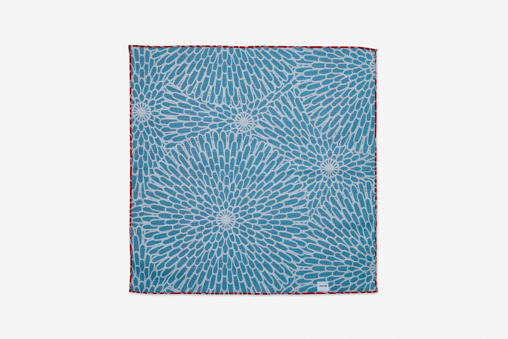 A square piece of material with blue with white background chrysanthemum pattern by Yamada Sen-I from Japan House London.