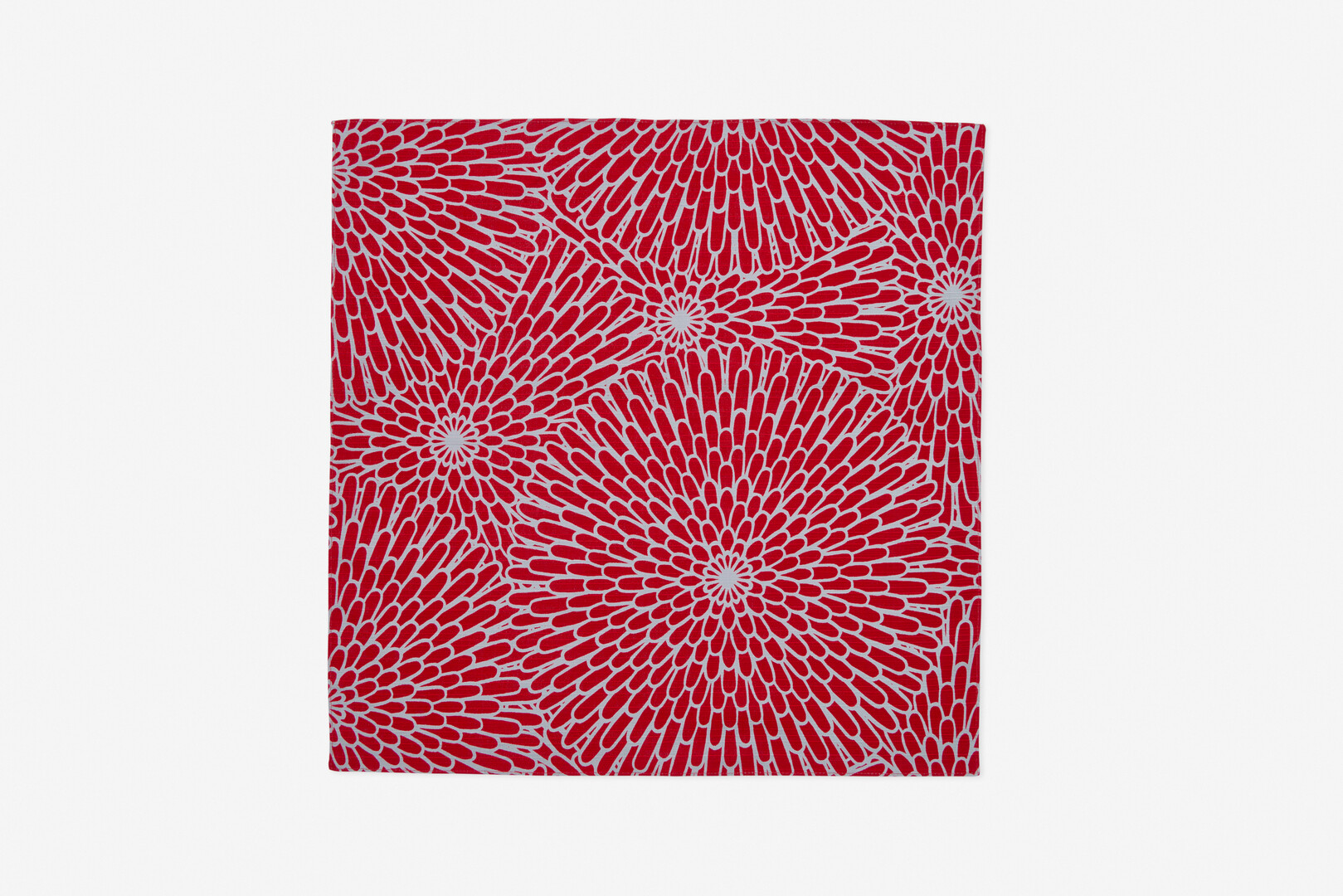 A square piece of material with red with blue background chrysanthemum pattern by Yamada Sen-I from Japan House London.