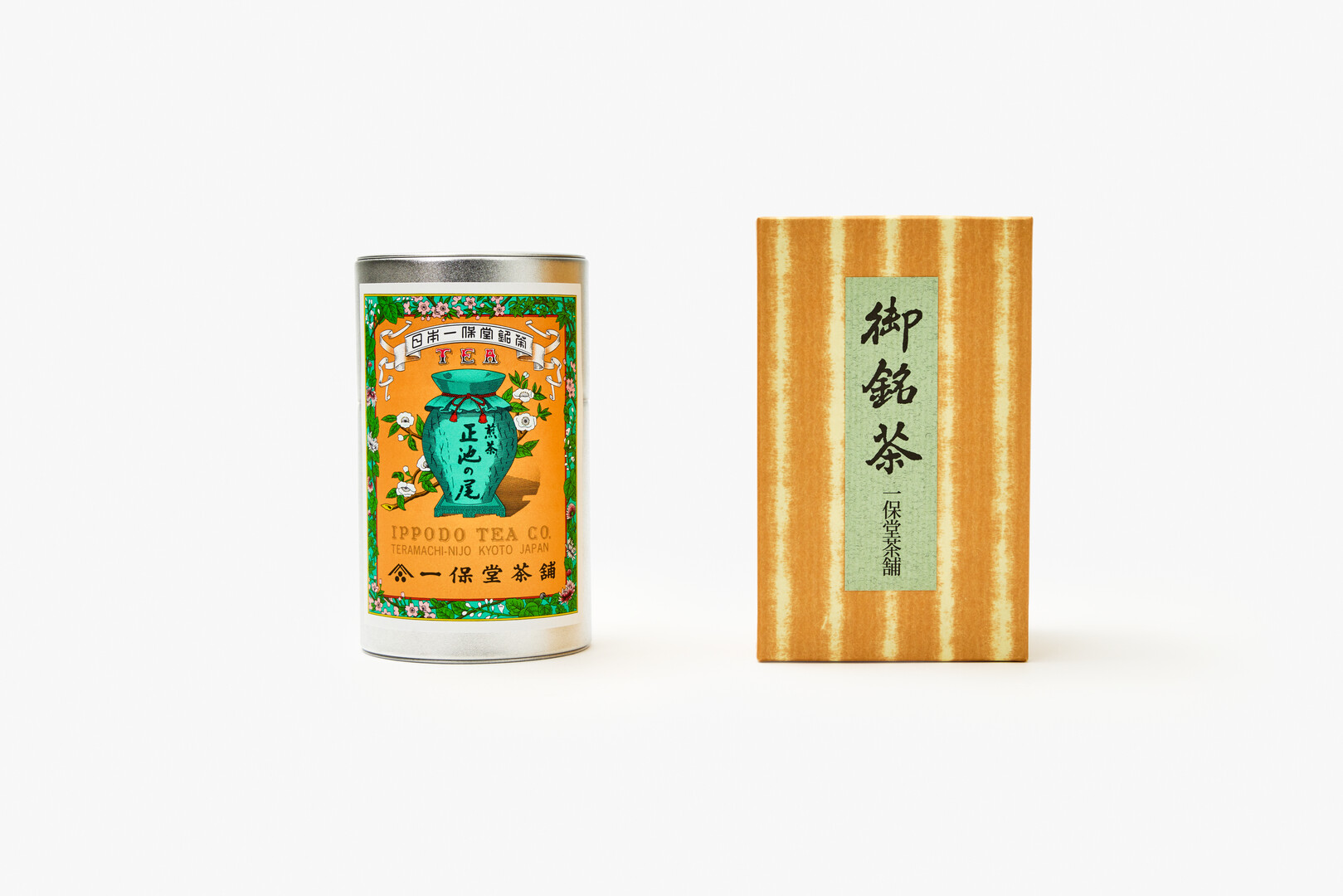 A can of IPPODO Sencha Shoike-no-o next to a orange and yellow striped box from Japan House London.