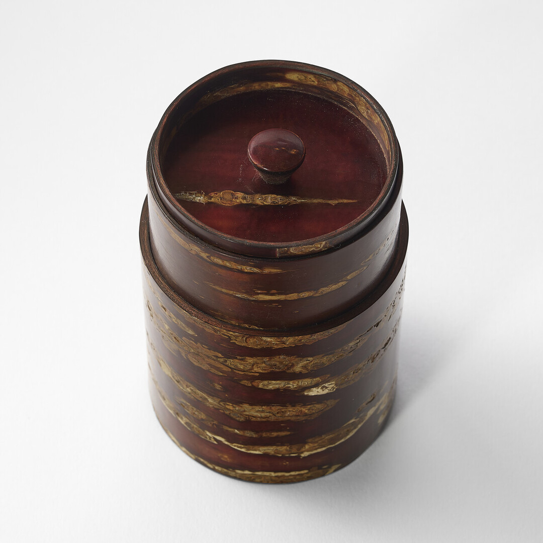 A deep red brown polished cherry bark tea caddy by Tomioka Shoten from Japan House London.