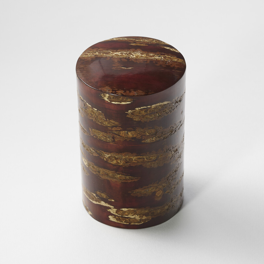 A deep red brown polished cherry bark tea caddy by Tomioka Shoten from Japan House London.