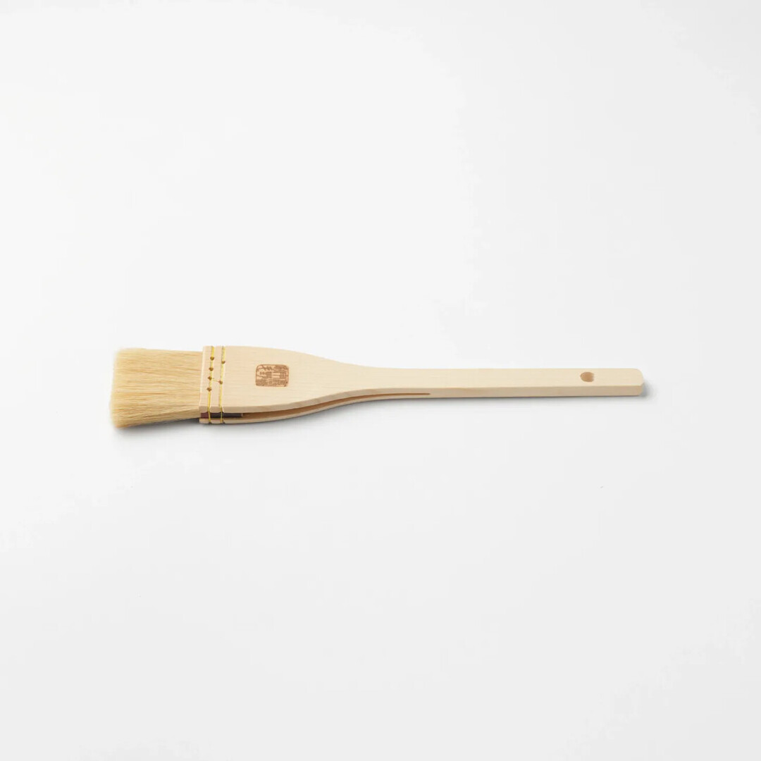 A Goat Hair Kitchen Brush with wooden handle by Unohake from Japan House London.