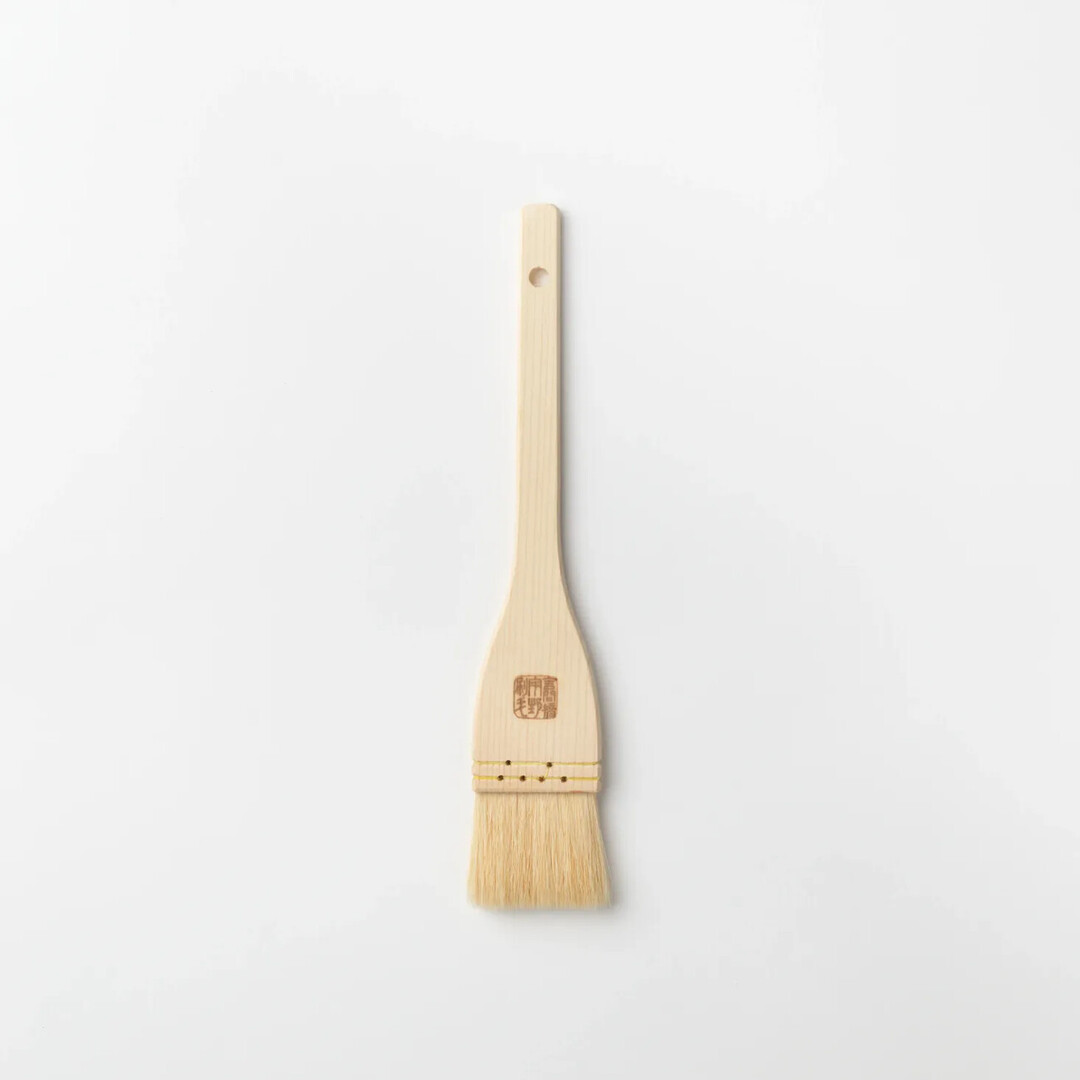 A Goat Hair Kitchen Brush with wooden handle by Unohake from Japan House London.